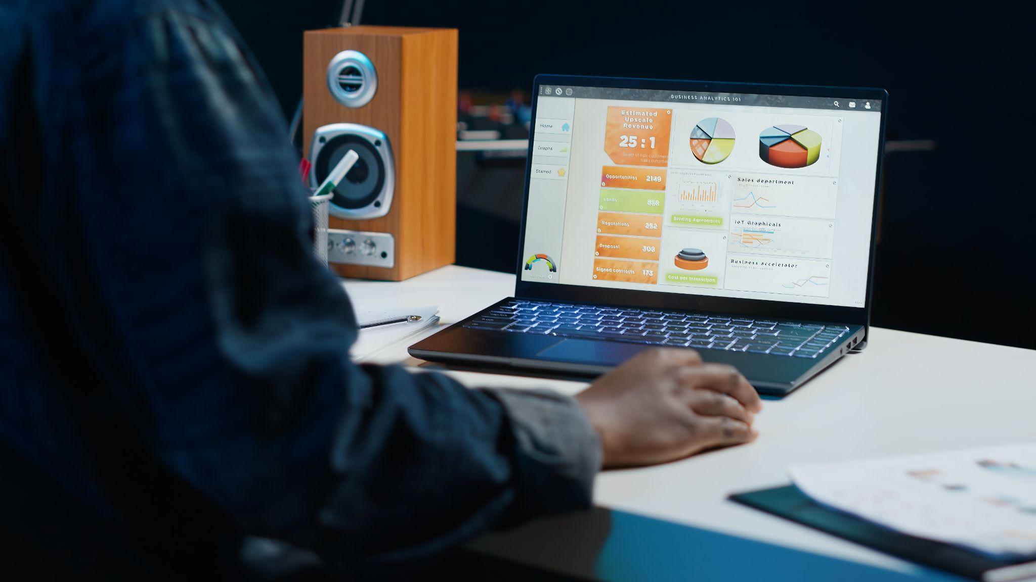 Entrepreneur reviewing ecommerce KPIs on a laptop while planning a new online store