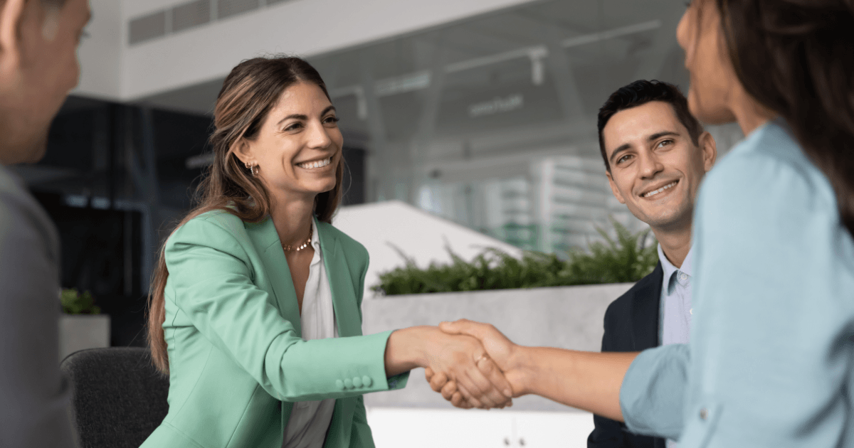 A handshake at a corporate meeting between two professionals