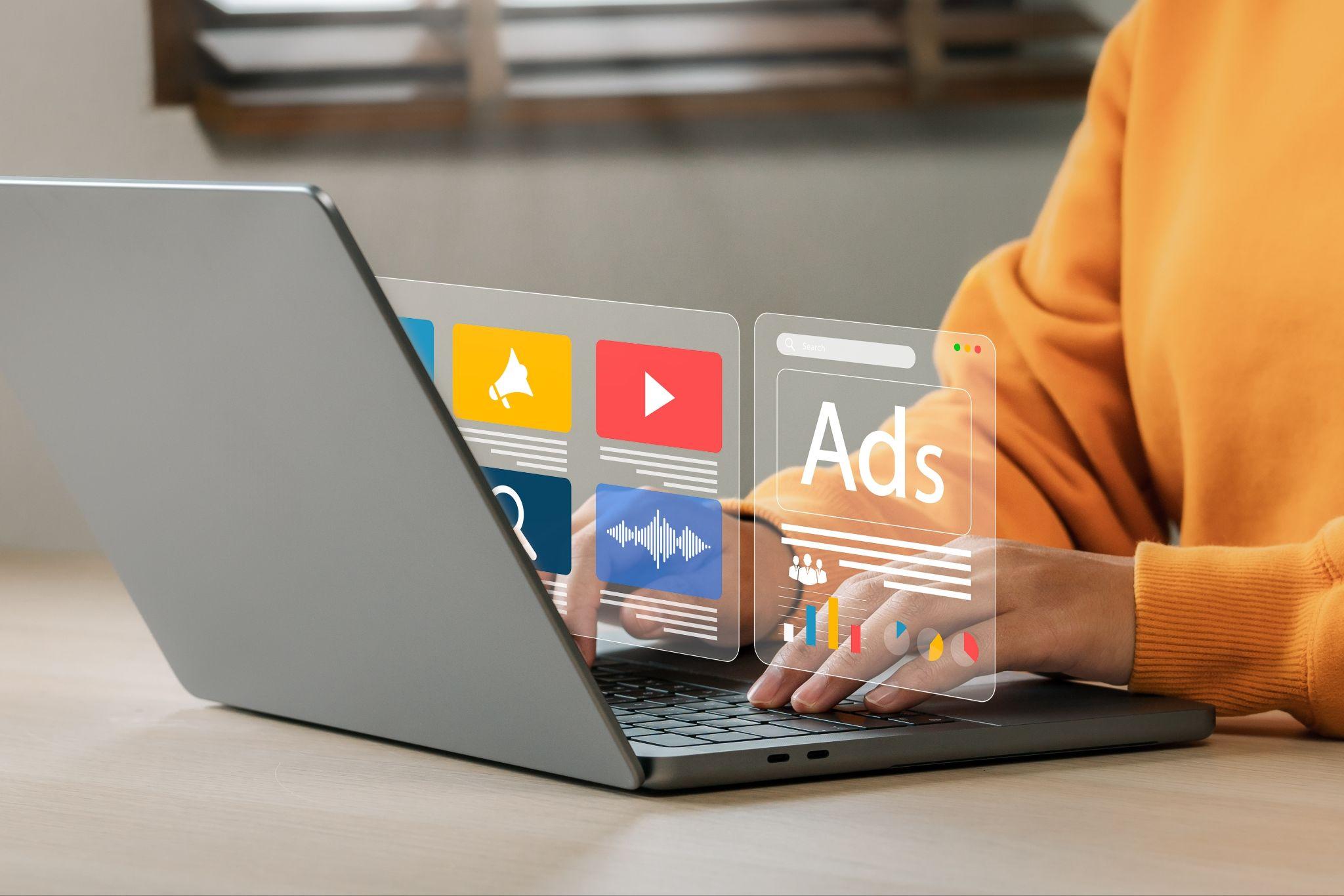 A person sat at a laptop with a graphic of different online platforms