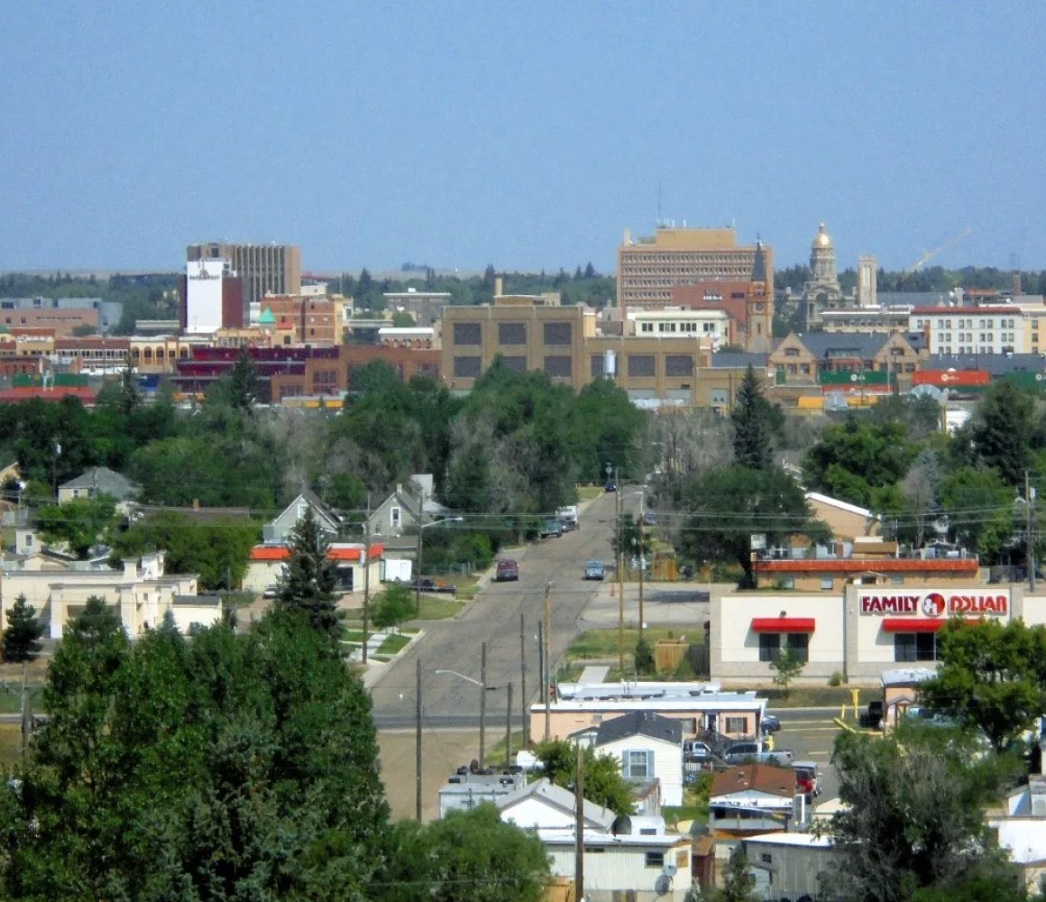 Tree-lined residential streets running toward the low Cheyenne skyline and its gold capitol dome