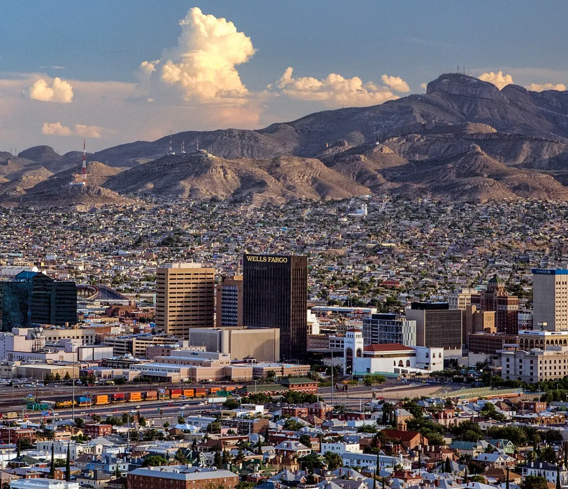Hillside view over El Paso's downtown towers and dense neighbourhoods to rugged desert mountains